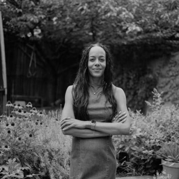 A black and white photo showing Lisa Lucas in her garden at home in Brooklyn.