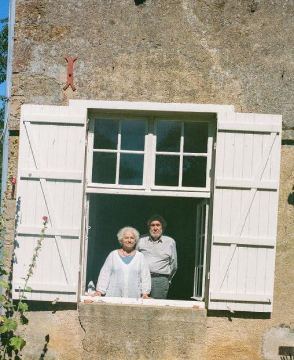 Larissa Volokhonsky, left, and Richard Pevear, framed by a white window, stand inside their home in Anthien, France.