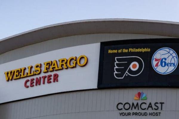 The Wells Fargo Center sign which reads “Home of the Philadelphia” and includes logos for the 76ers and the Flyers.