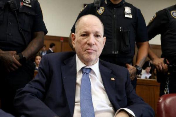 Harvey Weinstein sits in a courtroom.