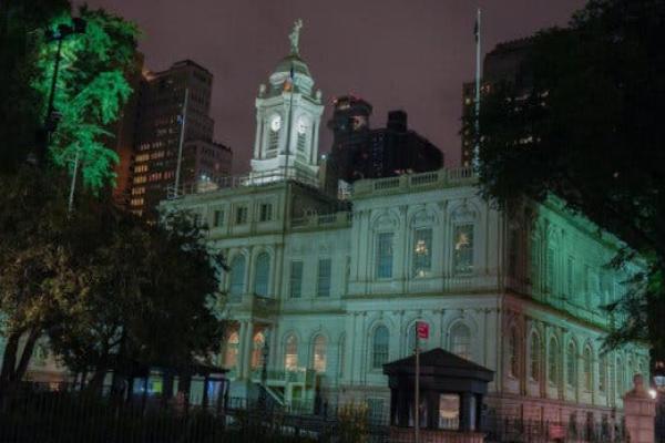 New York’s City Hall, illuminated at night.